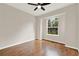 This bedroom features hardwood flooring, a ceiling fan, and a window that fills the space with natural light at 2009 E Grant St, Orlando, FL 32806