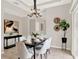 Dining room with an elegant light fixture, seating for six, and tiled floors at 2009 E Grant St, Orlando, FL 32806