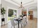 Dining area featuring a modern chandelier, seating for six, and a sliding glass door at 2009 E Grant St, Orlando, FL 32806