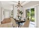 Dining room with modern chandelier, neutral colors, and sliding door for plenty of light at 2009 E Grant St, Orlando, FL 32806