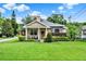 Charming home featuring manicured lawn, neutral colors, and decorative stone accents at 2009 E Grant St, Orlando, FL 32806