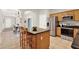 Charming kitchen featuring an island with granite countertop, stainless steel appliances and wooden cabinets at 2009 E Grant St, Orlando, FL 32806