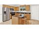 Charming kitchen featuring an island with granite countertop, stainless steel appliances and wooden cabinets at 2009 E Grant St, Orlando, FL 32806