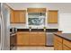 Charming kitchen featuring an island with granite countertop, stainless steel appliances and wooden cabinets at 2009 E Grant St, Orlando, FL 32806