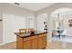 Kitchen island with granite countertops, wooden cabinetry, and seating for two, next to formal dining room at 2009 E Grant St, Orlando, FL 32806
