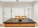 Kitchen island with granite countertops, wooden cabinetry, and seating for two at 2009 E Grant St, Orlando, FL 32806