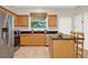 Charming kitchen featuring an island with granite countertop, stainless steel appliances and wooden cabinets at 2009 E Grant St, Orlando, FL 32806