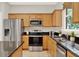 Kitchen featuring stainless steel appliances, granite countertops, and wooden cabinetry at 2009 E Grant St, Orlando, FL 32806