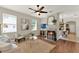 Bright living room with hardwood floors, a ceiling fan, and a stylish fireplace at 2009 E Grant St, Orlando, FL 32806