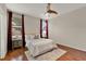 Bright and airy main bedroom with wood flooring, neutral tones, large windows and ceiling fan at 2009 E Grant St, Orlando, FL 32806