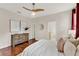 Bright and airy main bedroom with wood flooring, neutral tones, large windows and ceiling fan at 2009 E Grant St, Orlando, FL 32806