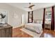 Bright and airy main bedroom with wood flooring, neutral tones, large windows and ceiling fan at 2009 E Grant St, Orlando, FL 32806