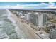 Stunning aerial view of the beachfront condo complex along a sandy beach with ocean frontage at 2055 S Atlantic Ave # 505, Daytona Beach, FL 32118