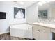 Bathroom with a corner tub and modern vanity at 2055 S Atlantic Ave # 505, Daytona Beach, FL 32118