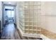 Bright bathroom featuring glass block wall and a tiled shower at 2055 S Atlantic Ave # 505, Daytona Beach, FL 32118