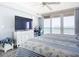Bright bedroom featuring a ceiling fan, large windows, and ocean views at 2055 S Atlantic Ave # 505, Daytona Beach, FL 32118