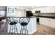 Modern kitchen features bar seating, white cabinets, dark counters, and stainless appliances at 2055 S Atlantic Ave # 505, Daytona Beach, FL 32118