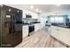 Modern kitchen featuring stainless steel appliances, white cabinets, and granite countertops at 2055 S Atlantic Ave # 505, Daytona Beach, FL 32118