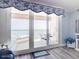 Living room with balcony access, ocean views, and 'Coastal' themed decor at 2055 S Atlantic Ave # 505, Daytona Beach, FL 32118