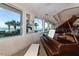View of a grand piano by the ocean-facing windows in a relaxing space at 2055 S Atlantic Ave # 505, Daytona Beach, FL 32118