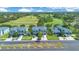 Stunning aerial view of townhomes overlooking lush golf course with manicured lawns on a bright and sunny day at 20610 Maxim Pkwy, Orlando, FL 32833