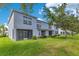 The unit's backyard displays a covered patio with ample green space at 20610 Maxim Pkwy, Orlando, FL 32833