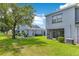 A view of the backyard with covered patio, grassy lawn, and nearby unit at 20610 Maxim Pkwy, Orlando, FL 32833