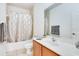 Bathroom with a shower and tub combination, vanity with a light wood cabinet and decorative towels at 20610 Maxim Pkwy, Orlando, FL 32833