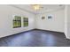 This spacious bedroom is bright with large windows and dark hardwood floors at 20610 Maxim Pkwy, Orlando, FL 32833