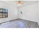 Bright bedroom features hardwood floors, a ceiling fan and natural light from two windows at 20610 Maxim Pkwy, Orlando, FL 32833