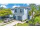 Well-maintained townhome features a two car garage, mature landscaping, and lush green lawn at 20610 Maxim Pkwy, Orlando, FL 32833