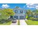 Two-story townhome features an attached two-car garage and a well manicured lawn at 20610 Maxim Pkwy, Orlando, FL 32833