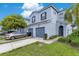 Light blue two story townhouse with a two car garage, concrete driveway and manicured lawn at 20610 Maxim Pkwy, Orlando, FL 32833