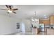 Open floor plan showcasing kitchen with stainless steel appliances, breakfast bar, and a modern hanging light fixture at 20610 Maxim Pkwy, Orlando, FL 32833