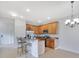 Open concept kitchen with wood cabinets, breakfast bar, and stainless steel appliances at 20610 Maxim Pkwy, Orlando, FL 32833