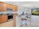Bright kitchen with stainless steel appliances, wooden cabinetry, granite countertops and eat in breakfast bar at 20610 Maxim Pkwy, Orlando, FL 32833