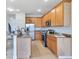 Kitchen featuring stainless steel appliances, breakfast bar, hanging lights, and wooden cabinets at 20610 Maxim Pkwy, Orlando, FL 32833