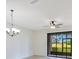 Bright room with a ceiling fan and sliding glass doors that offers great views of the lawn at 20610 Maxim Pkwy, Orlando, FL 32833
