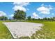 Community sand volleyball court with grassy border and mature shade tree at 20610 Maxim Pkwy, Orlando, FL 32833