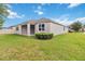 Spacious backyard featuring lush green grass and covered patio, perfect for outdoor enjoyment at 2066 Cresswell St, Ocoee, FL 34761
