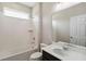 Bright bathroom featuring a tub with white tile surround and a vanity with quartz countertop at 2066 Cresswell St, Ocoee, FL 34761