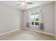 Bedroom with neutral carpet, a window with curtains, and a ceiling fan at 2066 Cresswell St, Ocoee, FL 34761