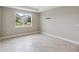 A blank slate bedroom with ample natural light and neutral tile floors at 2066 Cresswell St, Ocoee, FL 34761