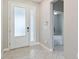 Bright foyer with large glass front door, tile flooring, and neutral paint at 2066 Cresswell St, Ocoee, FL 34761