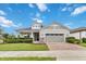 Charming single-story home with manicured lawn, brick driveway, and two-car garage at 2066 Cresswell St, Ocoee, FL 34761