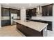 Contemporary kitchen featuring dark cabinets, stainless appliances, and a center island with stone countertop at 2066 Cresswell St, Ocoee, FL 34761