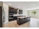 Modern kitchen with dark cabinetry, stainless steel appliances, and a large island at 2066 Cresswell St, Ocoee, FL 34761