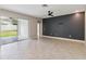 Spacious living area featuring tile floors, sliding glass doors to the backyard, and a modern ceiling fan at 2066 Cresswell St, Ocoee, FL 34761