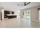 Open-concept living space with tile flooring, modern ceiling fan, and sliding glass doors to the outdoors at 2066 Cresswell St, Ocoee, FL 34761