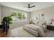 Staged main bedroom with a large window, modern fan, and neutral decor at 2066 Cresswell St, Ocoee, FL 34761